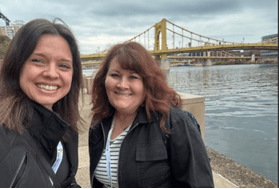 Bailey and ElizaBeth with the Three Sisters bridges in Pittsburgh at NAGC25.