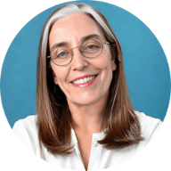 A person with glasses smilingAI-generated content may be incorrect.