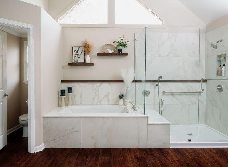 A bathroom with a glass shower and a tubAI-generated content may be incorrect.