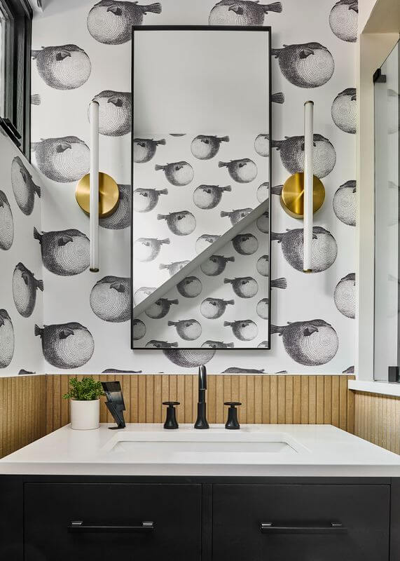 A bathroom with a mirror and a wallpaperAI-generated content may be incorrect.