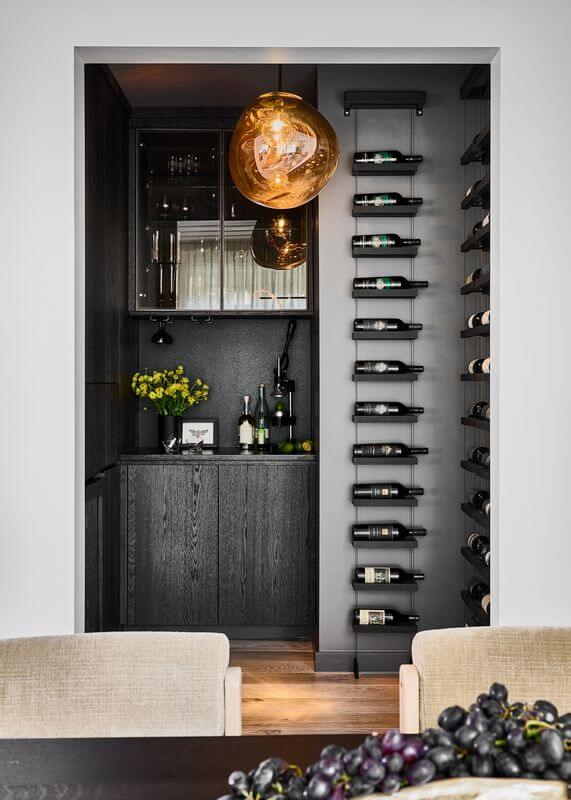 A wine rack with bottles from itAI-generated content may be incorrect.