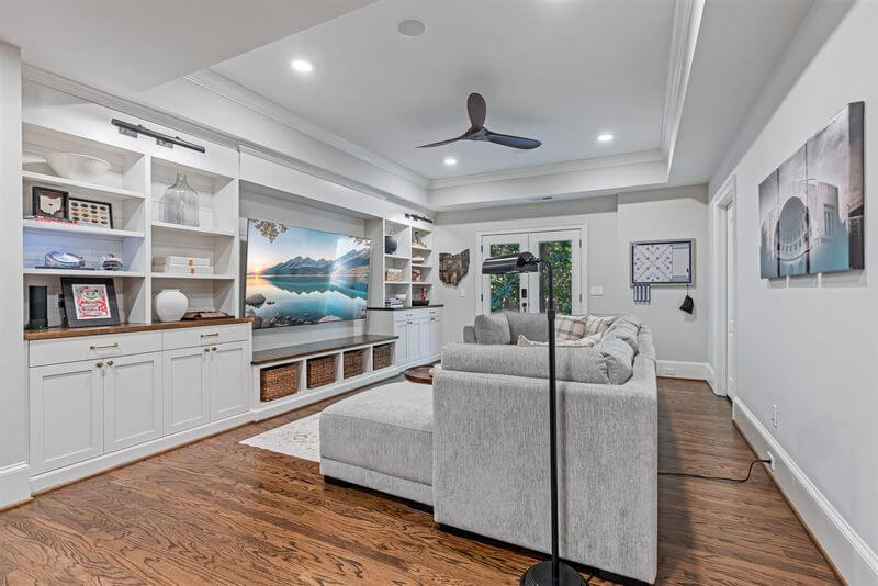 A living room with a couch and a fan