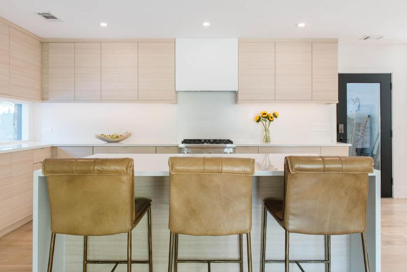 A kitchen with a countertop and chairsAI-generated content may be incorrect.