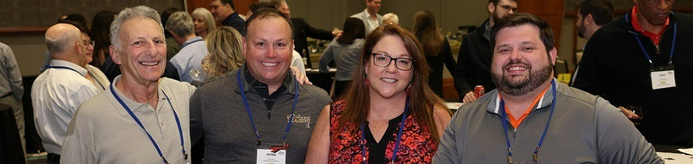 four smiling NFFS conference attendees