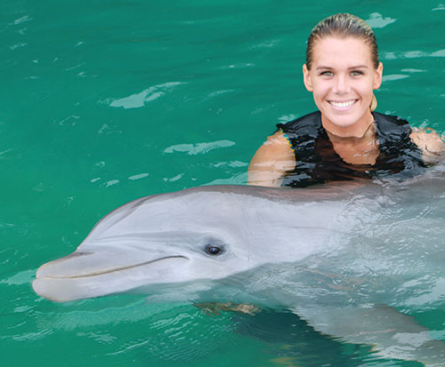 dolphin and woman in water