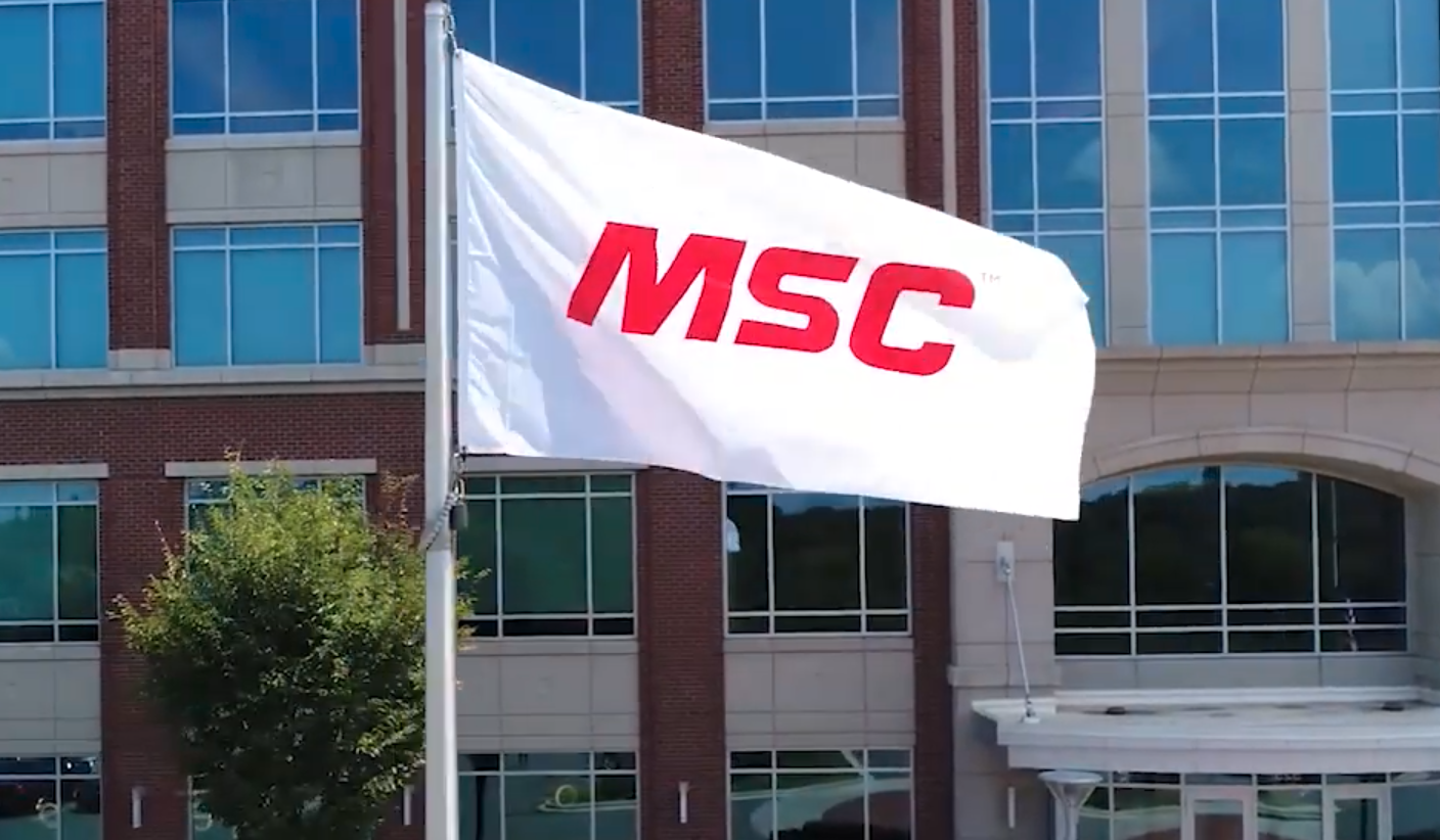 white flag with MSC logo in front of office building