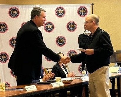 Jerrod Weaver shaking hands with Navy representative