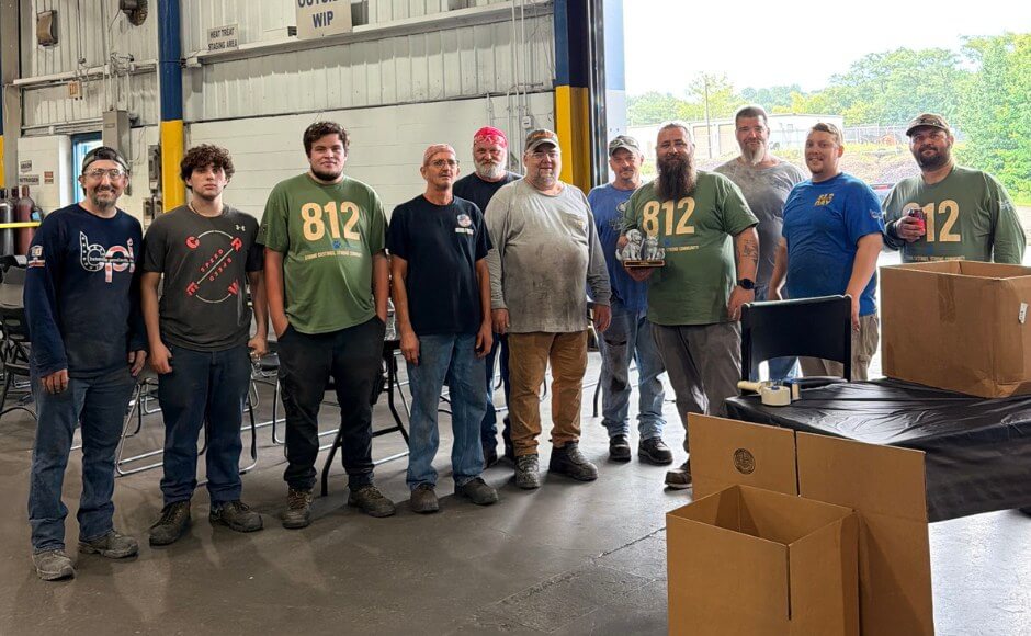 Group gathered inside a Batesville Products facility