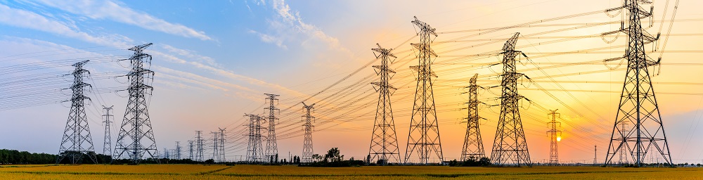 paranoramic view of electric lines in front of a sunset