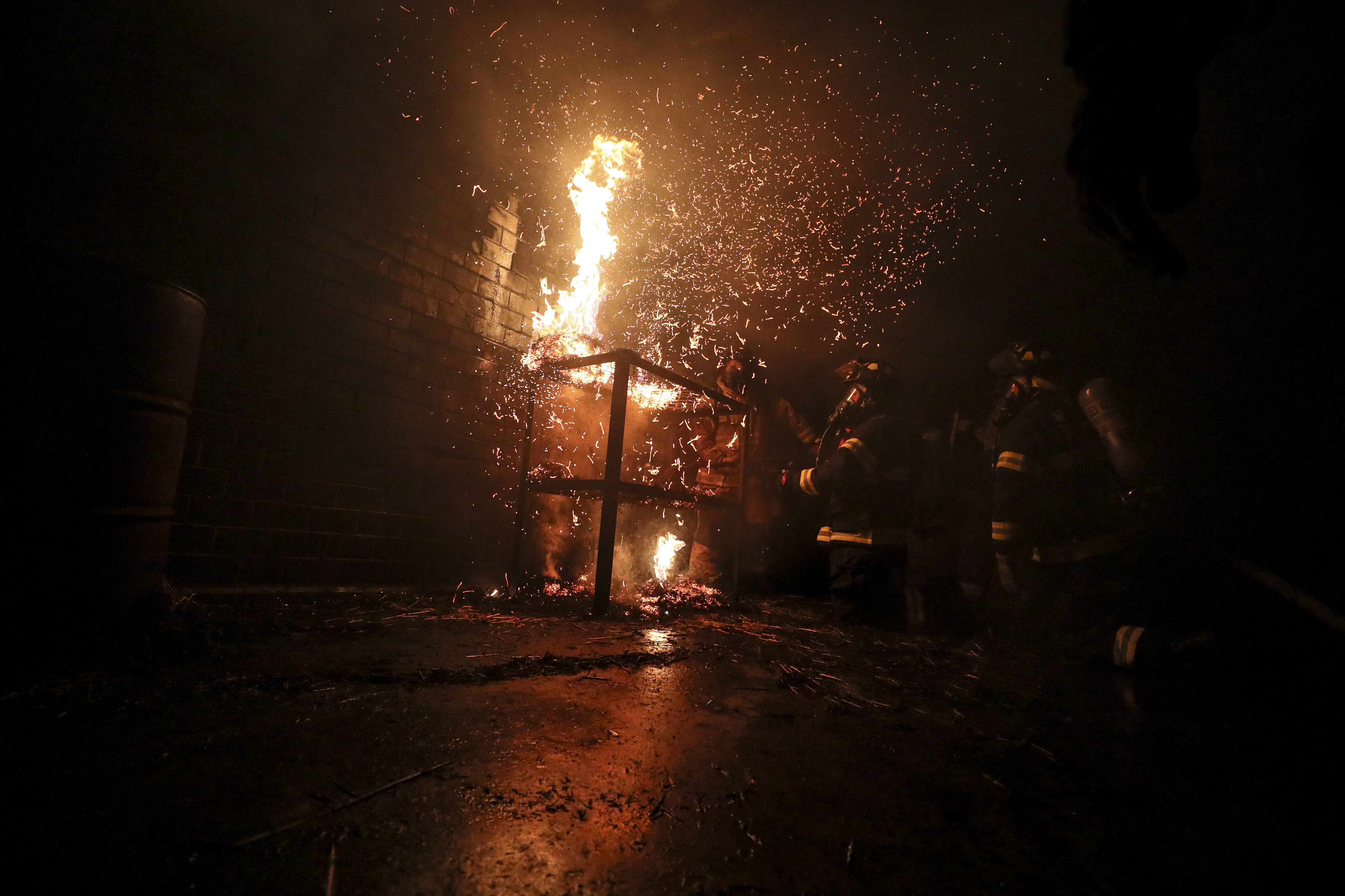 fire with sparks inside a dark building