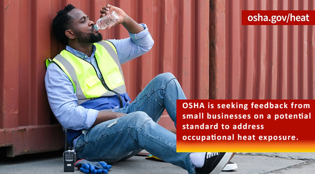 worker sitting and drinking water to take a break from the heat