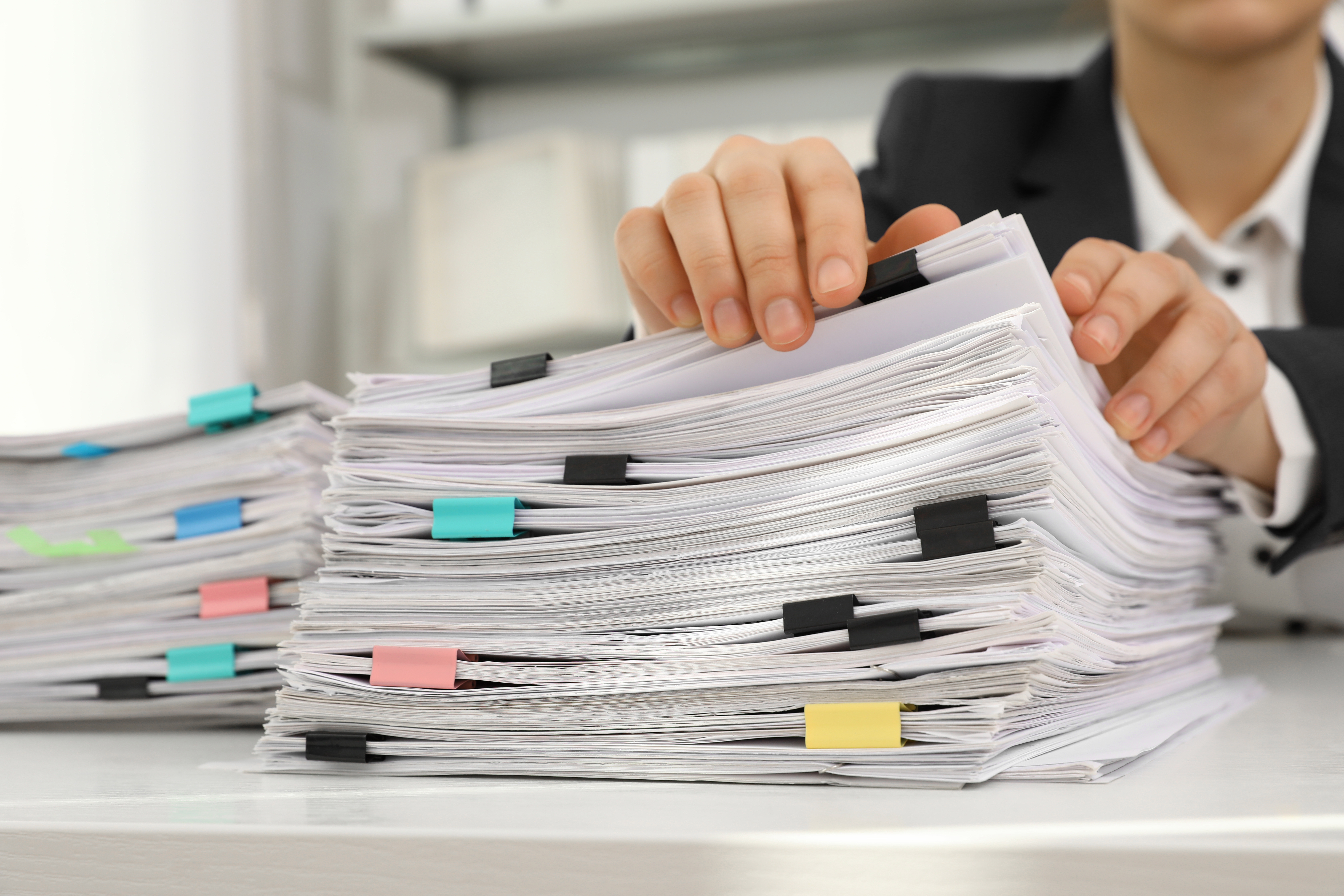 stack of paper files several inches tall