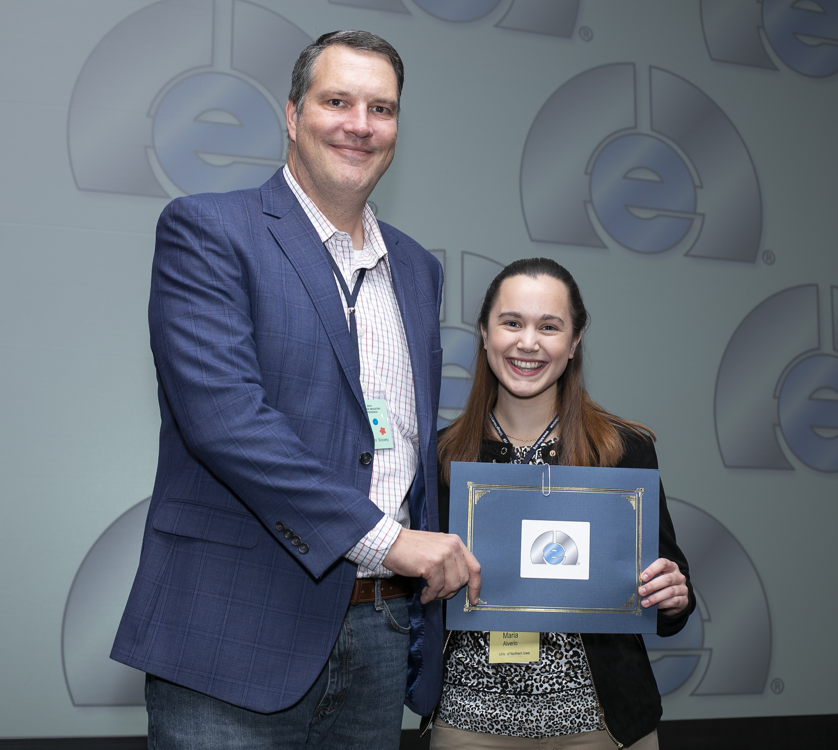 NFFS Executive Director Jerrod Weaver shaking hands with 2019 NFFS scholarship winner Maria Alverio