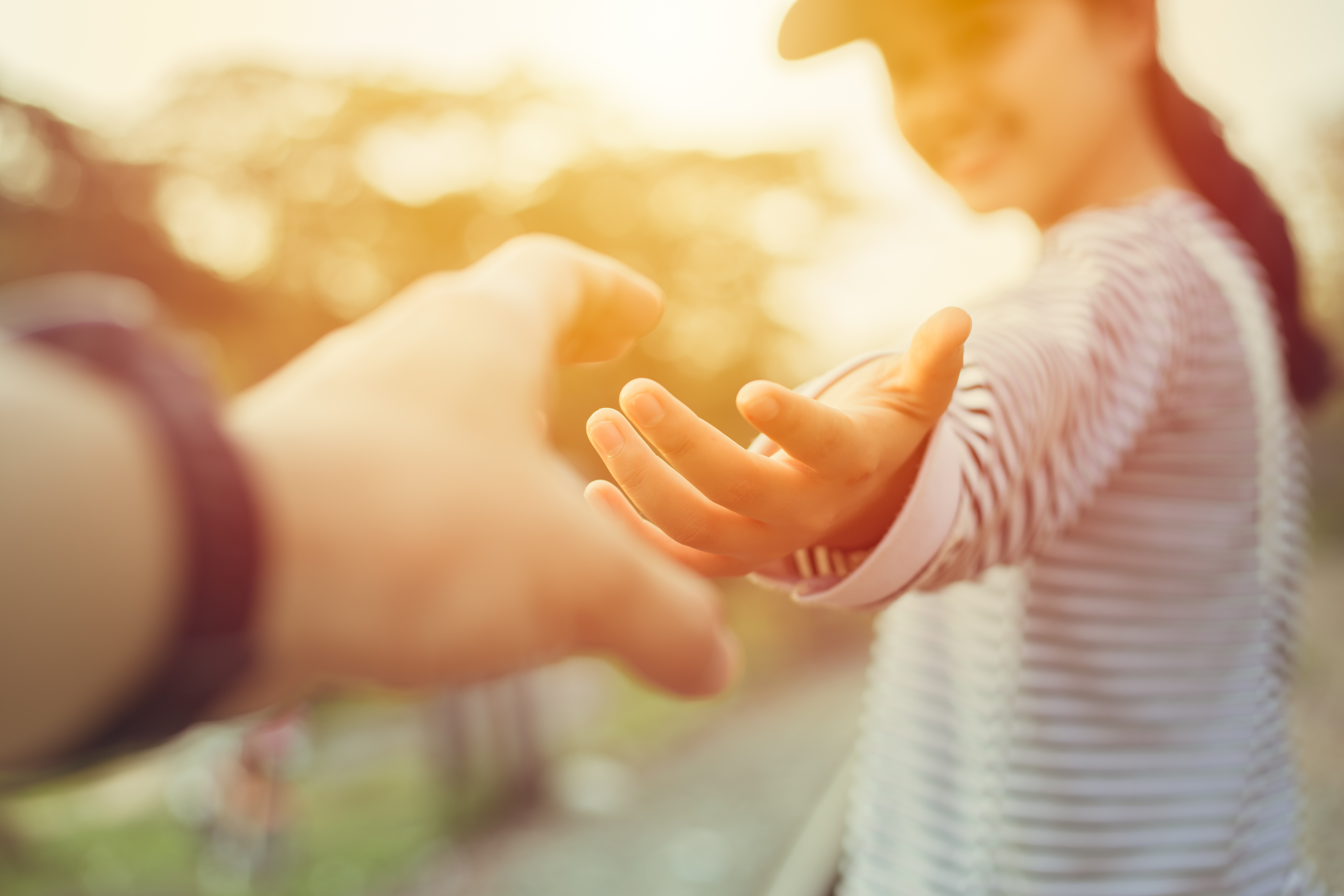 A person turns to grab the hand of another