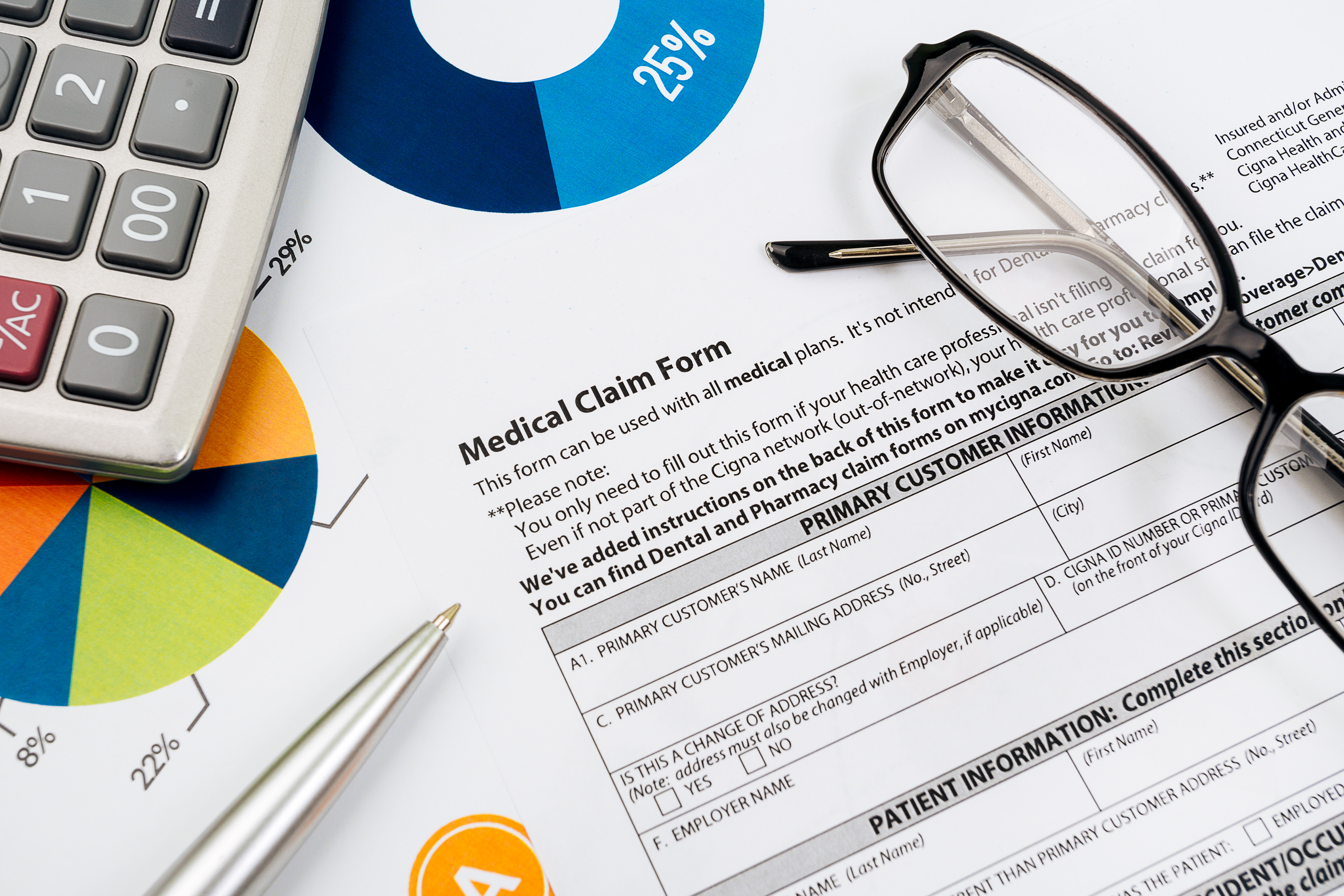 medical claim forms and a pen