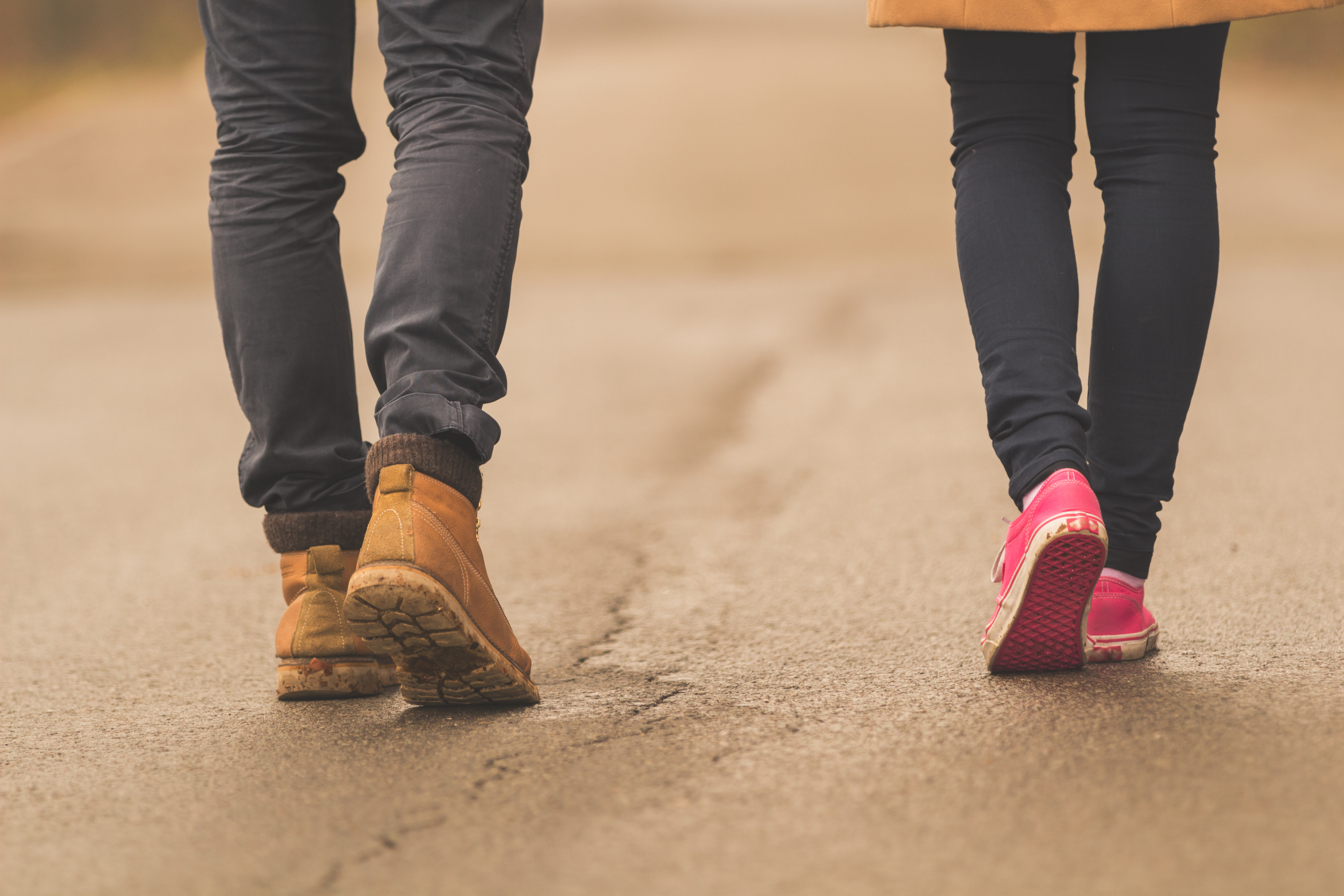 A therapist and client take a walk down a road.