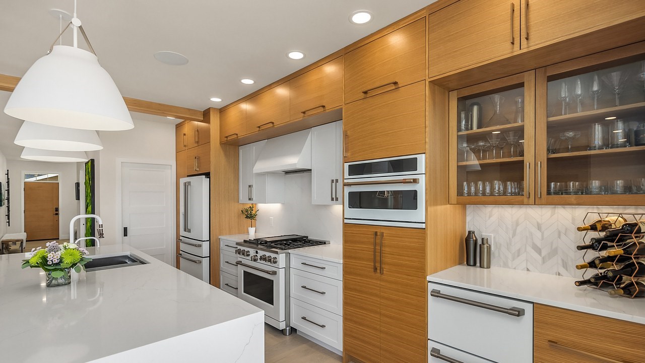 Kitchen remodel in Issaquah, WA with white oak cabinets and waterfall island by Higgason Homes