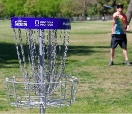 A person playing frisbee in a parkDescription automatically generated with medium confidence
