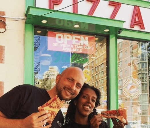 Kobi and Abev enjoying Pleese&reg; Pizza outside of a New York City pizza joint
