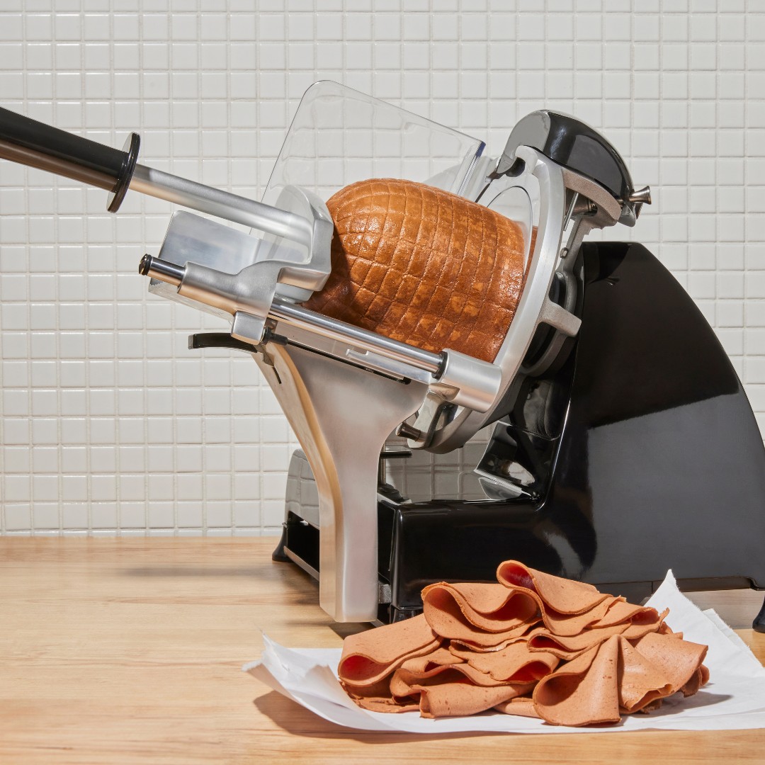 Prime Roots plant-based deli meat on a deli slicer