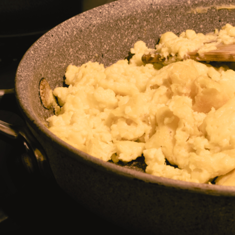Plant-based eggs cooking in a frying pan.