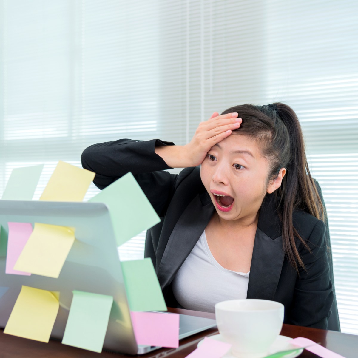 Woman Overwhelmed at Laptop
