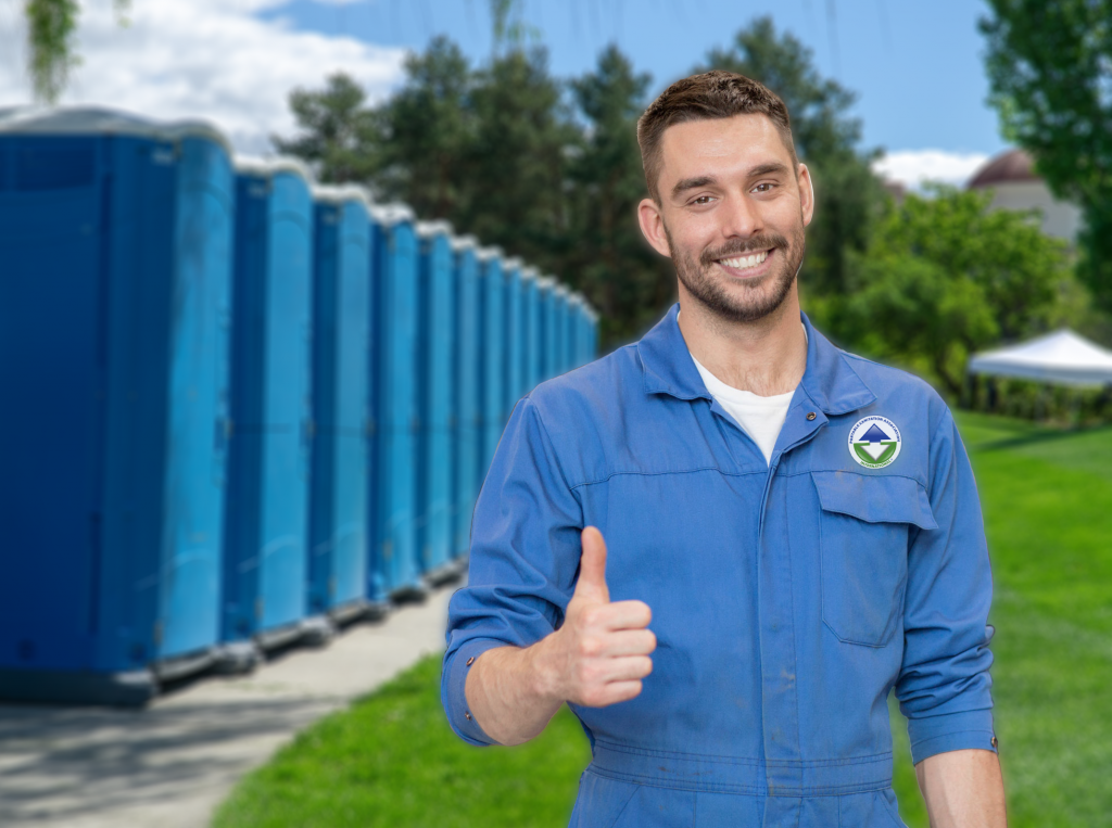 portable sanitation service technician in foreground with portable sanitation units in the background