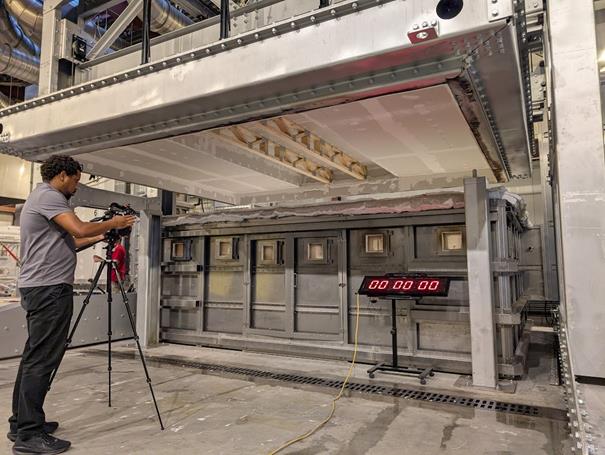 Technician documenting the floor furnace test with a camera