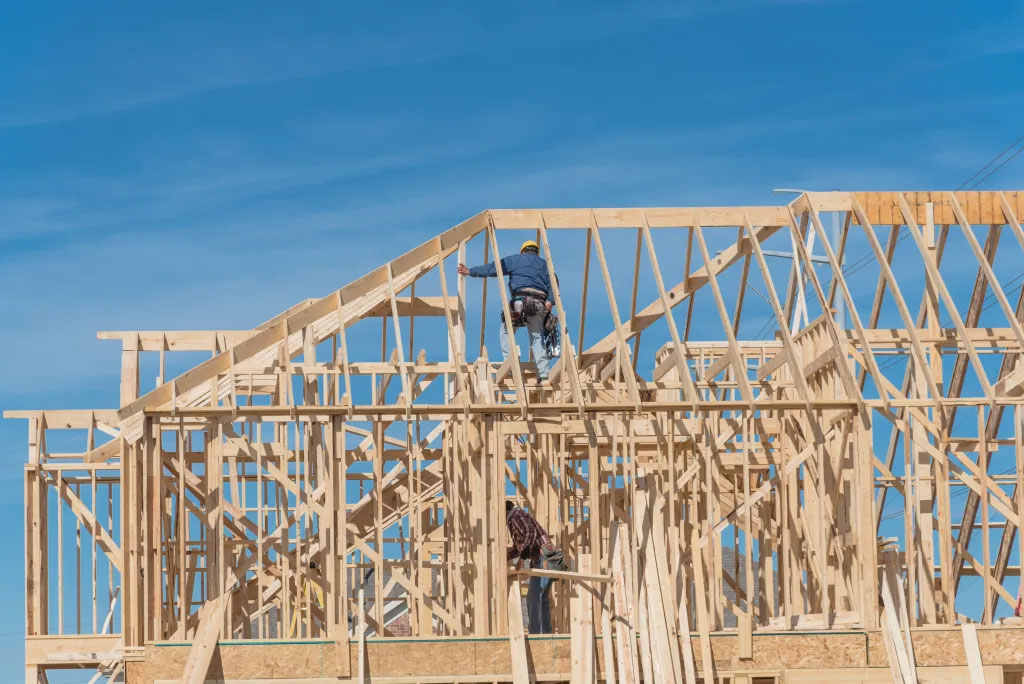 Workers in roofing trusses