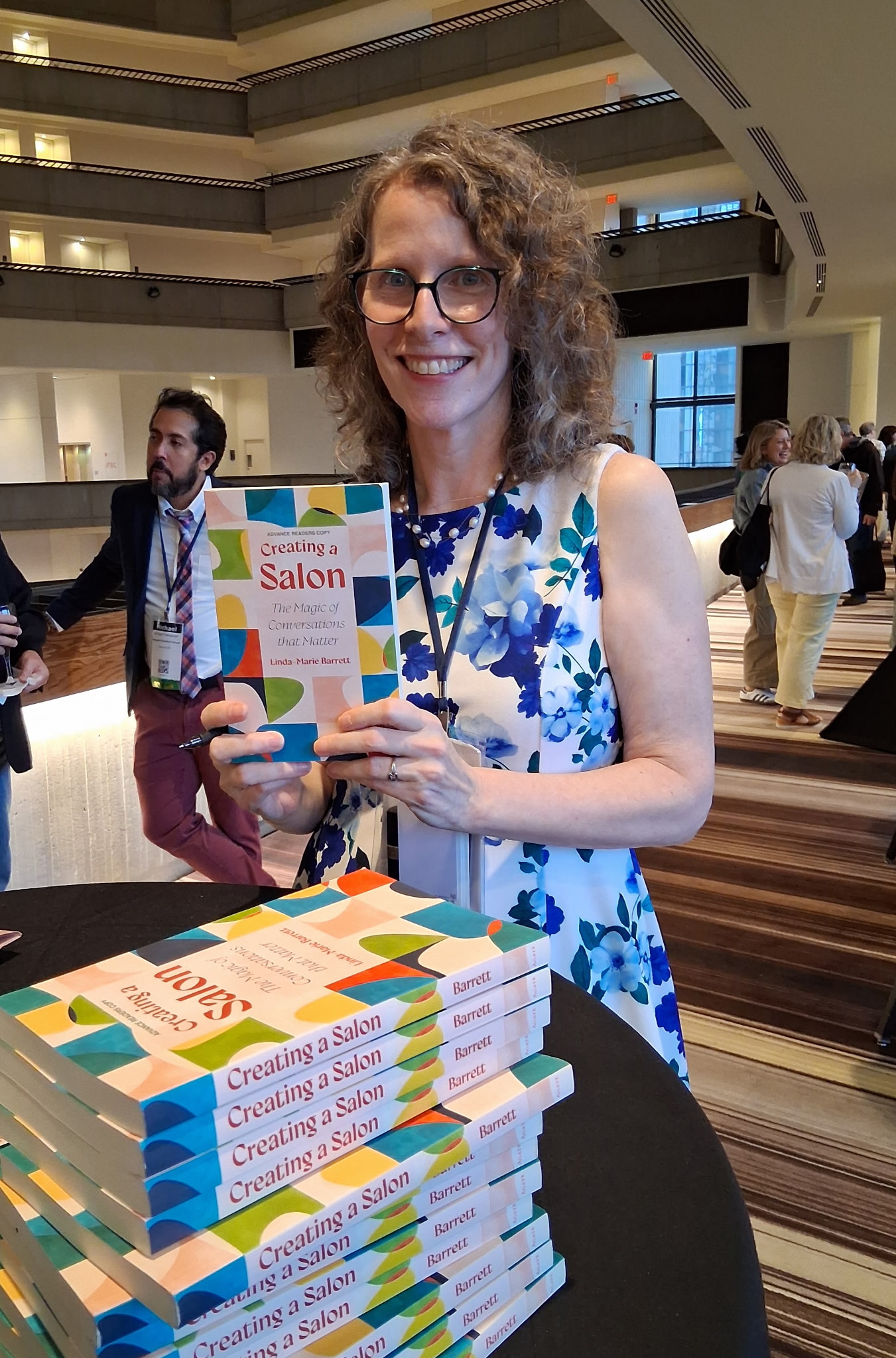 Linda-Marie Barrett signing books at NVNR 2025 in Atlanta, GA. Photo credit Jon Mayes