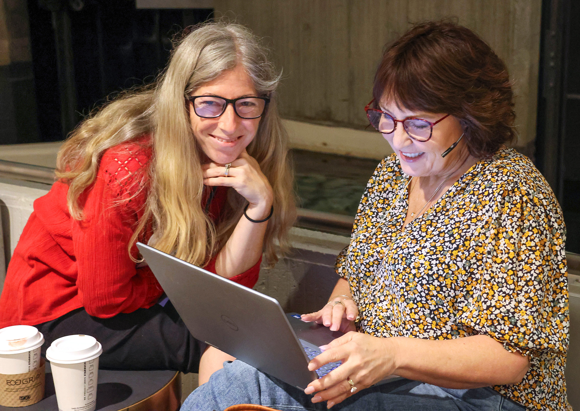 Two women sharing a computer screen at NVNR 2025