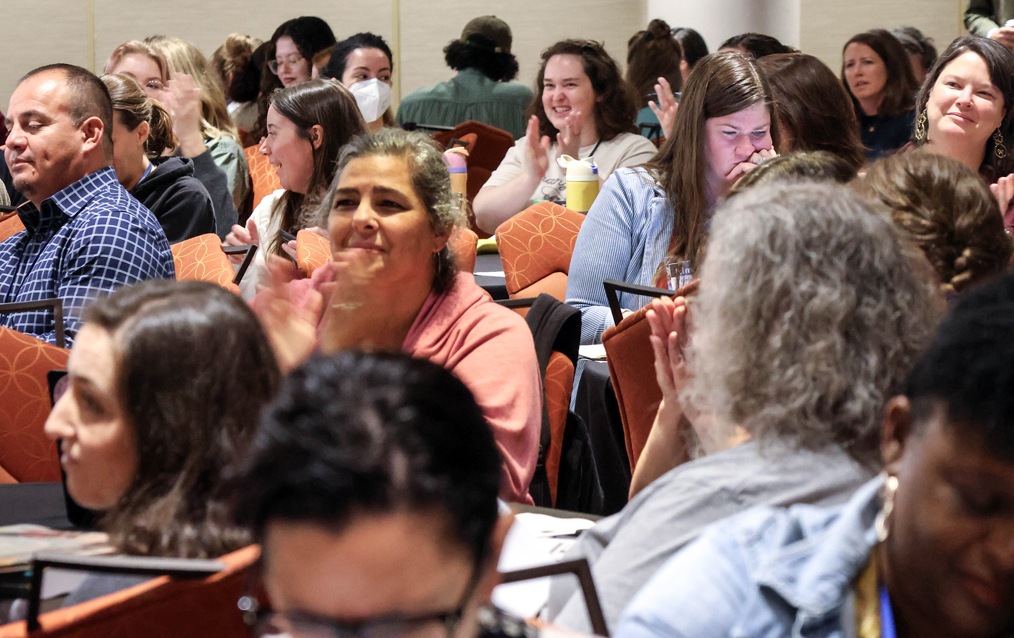 Gathering of booksellers applauding at a SIBA event