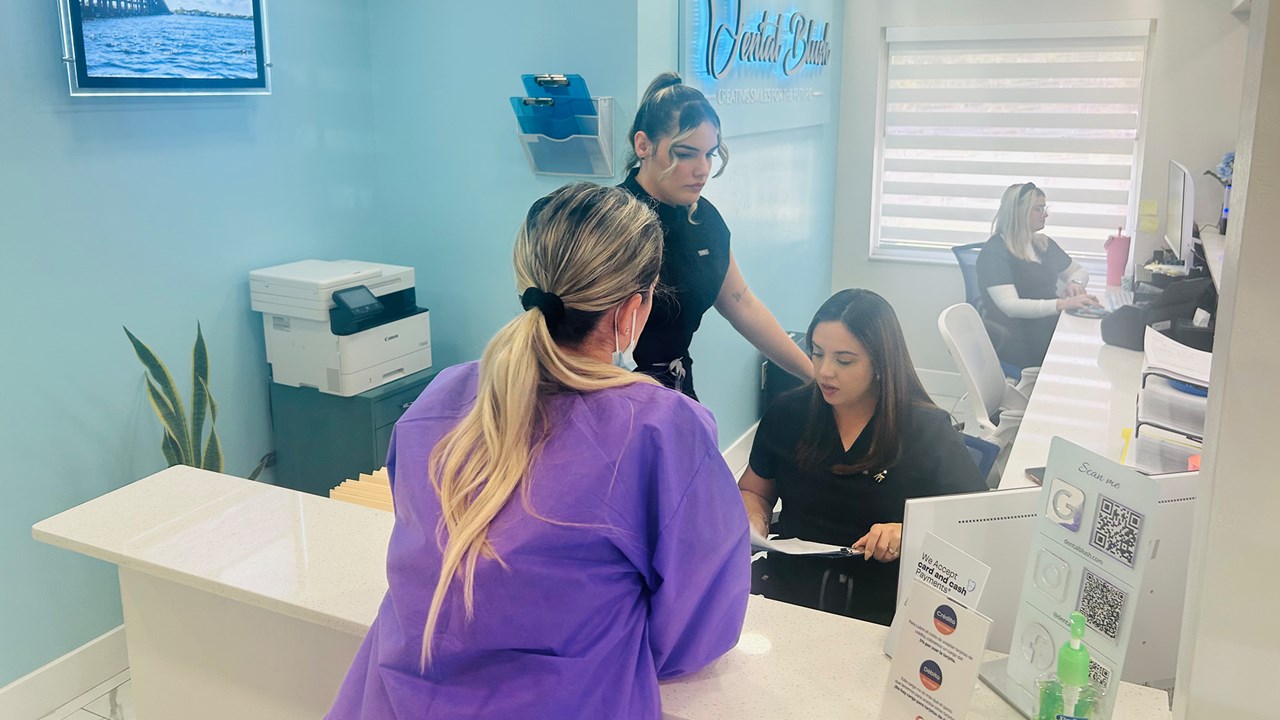 Dental Blush Cape Coral front desk team assisting a patient at the dental office