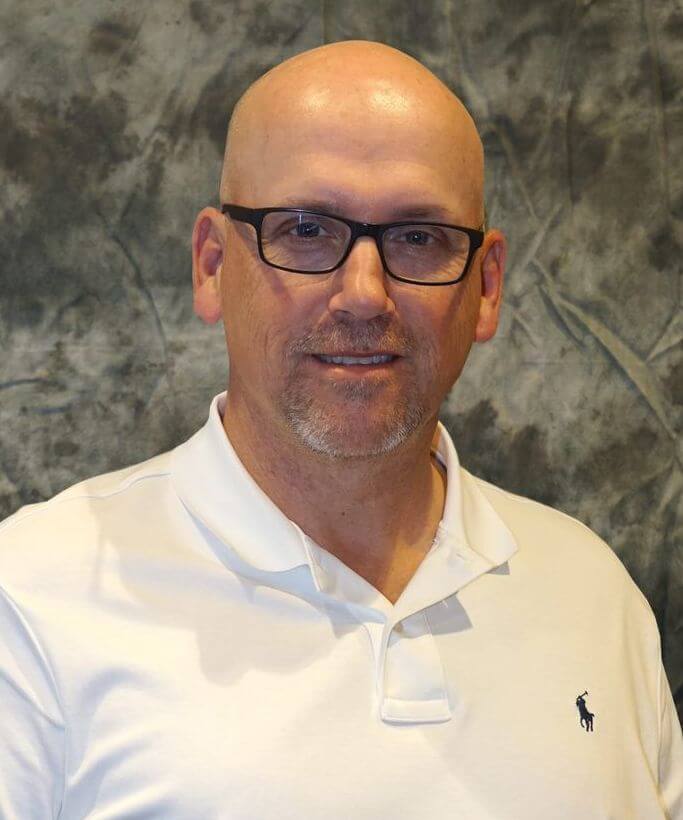 A person wearing glasses and a white polo shirtAI-generated content may be incorrect.