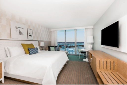 A room with a large bed and a televisionAI-generated content may be incorrect.