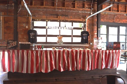 A long table with red and white striped curtainsAI-generated content may be incorrect.