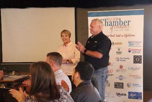 A person and person standing in front of a group of peopleAI-generated content may be incorrect.