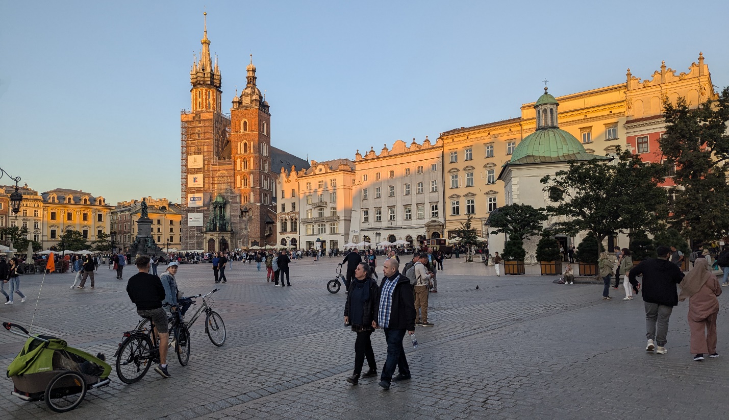 People walking in a plazaDescription automatically generated