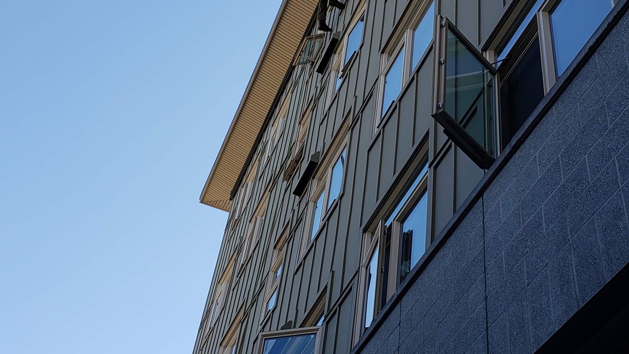 Navigating a particularly difficult overhang during a window cleaning.