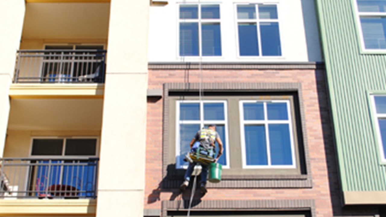 Window cleaning a mid-rise building.